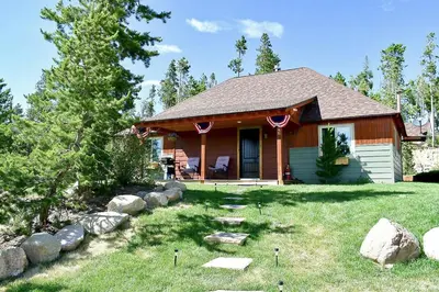 a small house with a yard with rocks at Blackhawk in Grand Lake
