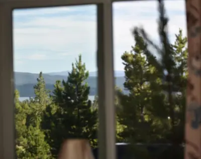 a window with a view of trees in the background at Blackhawk in Grand Lake