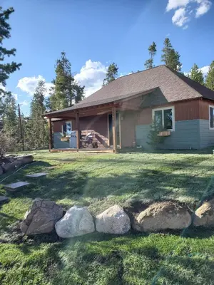 a house with rocks in front of it at Blackhawk in Grand Lake