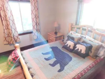 a childs bedroom with a wooden bed with animals on it at Blackhawk in Grand Lake