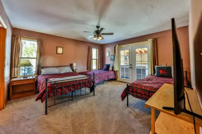 a bedroom with two beds and a ceiling fan at Bluejay bunkhouse in Grand Lake