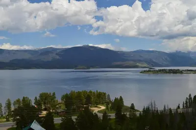 a view of a large lake with trees and mountains at Bluejay bunkhouse in Grand Lake