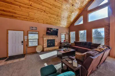 a living room with a couch and a fireplace at Bluejay bunkhouse in Grand Lake