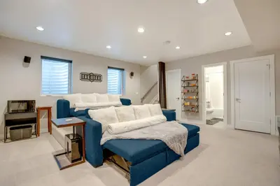 a living room with a blue couch and a table at 1 Mi to Dtwn Denver Sleek Duplex with Rooftop Deck! in Denver