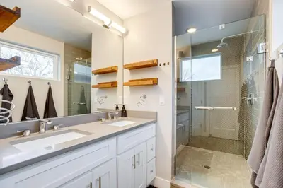 a bathroom with two sinks and a shower at 1 Mi to Dtwn Denver Sleek Duplex with Rooftop Deck! in Denver