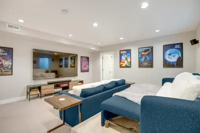 a living room with two blue couches and a table at 1 Mi to Dtwn Denver Sleek Duplex with Rooftop Deck! in Denver