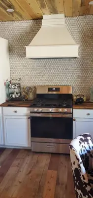 a kitchen with a stove top oven in a kitchen at Cowboy cabin in Grand Lake