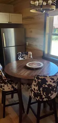 a wooden table with two chairs and a plate on it at Cowboy cabin in Grand Lake