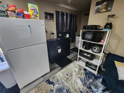 a kitchen with a white refrigerator in a room at Entire Basement with private Entrance within walking distance from the Gaylord hotel in Aurora
