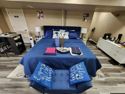 a large blue bed with a tray of food on it at Entire Basement with private Entrance within walking distance from the Gaylord hotel in Aurora