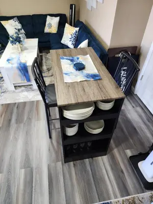 a table with plates on top of it in a living room at Entire Basement with private Entrance within walking distance from the Gaylord hotel in Aurora
