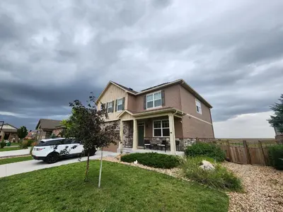 a house with a car parked in the driveway at Entire Basement with private Entrance within walking distance from the Gaylord hotel in Aurora