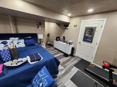 a bedroom with a bed with a boat on it at Entire Basement with private Entrance within walking distance from the Gaylord hotel in Aurora