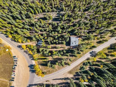 an overhead view of a road with cars and trees at Nestled Inn Vacation Home Rental Evergreen - Trails, Views, Hot Tub, Skiing! in Evergreen