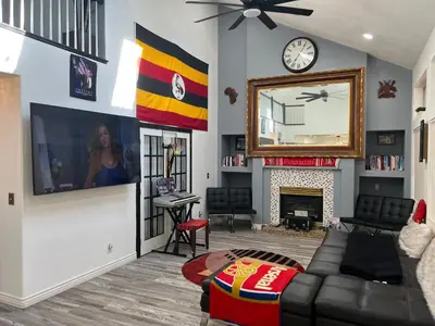 a living room with a couch and a mirror at DIA Layover B&B in DEN