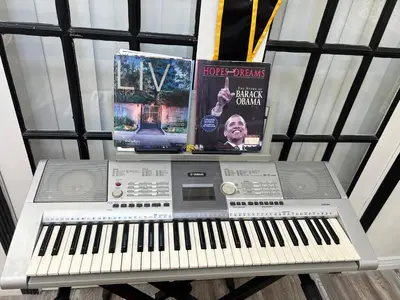 a keyboard and a music system with two books at DIA Layover B&B in DEN