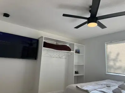a bedroom with a ceiling fan and a bed at DIA Layover B&B in DEN