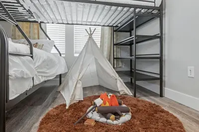 a childs bedroom with a bed and a toy tent at 3br W King Bed, Sauna, Parking-6 Min To Olde Town in Arvada