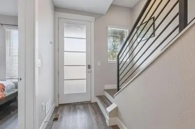 a hallway with a door leading to a bedroom at 3br W King Bed, Sauna, Parking-6 Min To Olde Town in Arvada