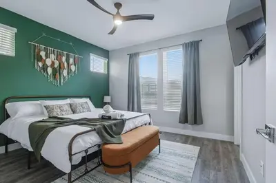 a green bedroom with a bed and a ceiling fan at 3br W King Bed, Sauna, Parking-6 Min To Olde Town in Arvada