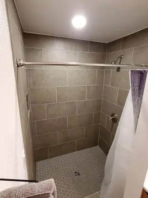 a bathroom with a shower with a shower curtain at Beautiful Cabin with Fire Pit and Deck in Foxpark, Wyoming in Foxpark