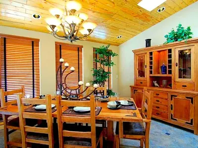 a dining room with a wooden table and chairs at Spacious Cabin with Breathtaking Views near Rocky Mountain National Park, Colorado in Estes Park