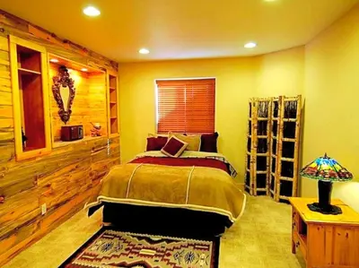 a bedroom with a bed and a table with a lamp at Spacious Cabin with Breathtaking Views near Rocky Mountain National Park, Colorado in Estes Park