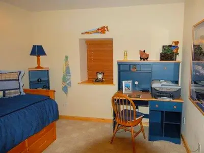 a bedroom with a bed and a desk with a computer at Spacious Cabin with Breathtaking Views near Rocky Mountain National Park, Colorado in Estes Park