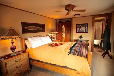 a bedroom with a bed and a dresser with a lamp at Western-Style Ranch Getaway for Two Guests near Fort Collins, Colorado in Livermore