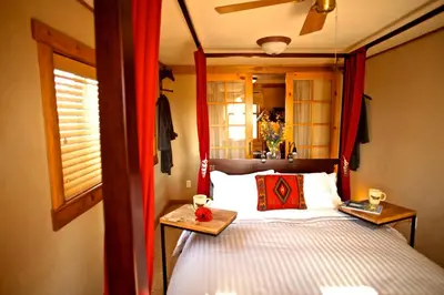 a bedroom with a canopy bed with a table on it at Gorgeous Ranch Stay Accommodation with Amazing Views in Livermore, Colorado in Livermore