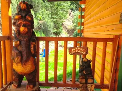 a statue of two bears on a porch at Spacious Cabin Rental with a Hot Tub for a Weekend Getaway near Denver, Colorado in Idaho Springs