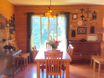 a dining room with a table and a window at Spacious Cabin Rental with a Hot Tub for a Weekend Getaway near Denver, Colorado in Idaho Springs