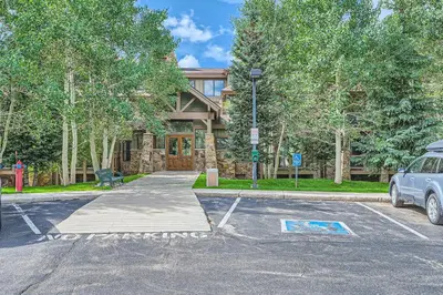 a car parked in a parking lot in front of a house at Cozy 1BR Near Trails with Shuttle to Slopes and Town in Breckenridge