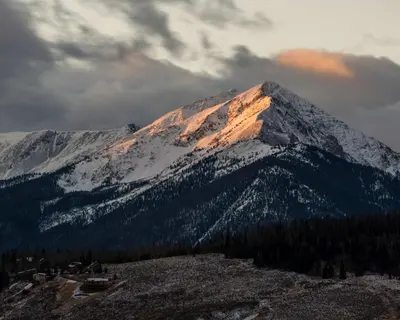 a mountain covered in snow with the sun shining on it at Cozy 1BR Near Trails with Shuttle to Slopes and Town in Breckenridge