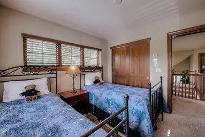 a bedroom with two beds with teddy bears on them at Beautiful Unit in Quiet Area with Shuttle to Slopes in Breckenridge
