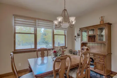 a dining room with a table and chairs and a chandelier at Beautiful Unit in Quiet Area with Shuttle to Slopes in Breckenridge