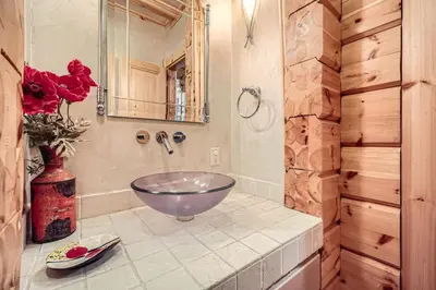 a bathroom with a bowl sink and a mirror at Luxury Home for 12 with Hot Tub Sauna & Mtn Views in Breckenridge