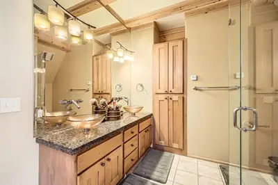 a bathroom with three sinks and a shower at Luxury Home for 12 with Hot Tub Sauna & Mtn Views in Breckenridge