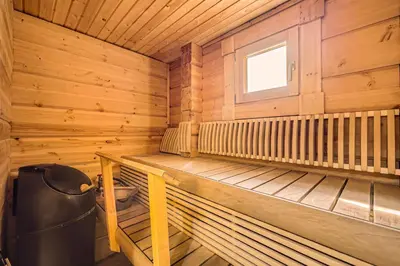 a wooden cabin with a bench and a window at Luxury Home for 12 with Hot Tub Sauna & Mtn Views in Breckenridge
