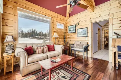 a living room with a couch and a table at Luxury Home for 12 with Hot Tub Sauna & Mtn Views in Breckenridge