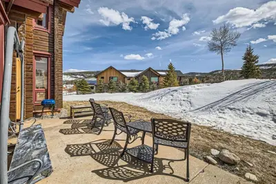 a patio with chairs and a table and snow at Luxury Home for 12 with Hot Tub Sauna & Mtn Views in Breckenridge
