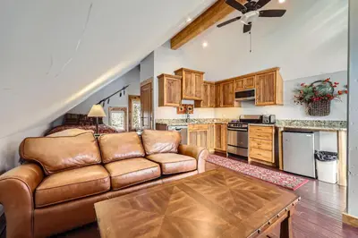 a living room with a couch and a table at Luxury Home for 12 with Hot Tub Sauna & Mtn Views in Breckenridge