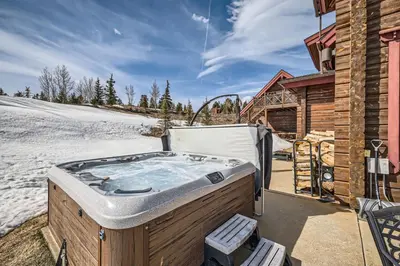 a hot tub in the snow next to a cabin at 3BDR with Loft for 8 Hot Tub Sauna & Mtn Views in Breckenridge