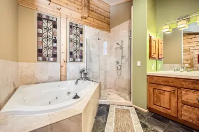 a bathroom with a tub and a shower and a sink at 3BDR with Loft for 8 Hot Tub Sauna & Mtn Views in Breckenridge