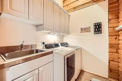 a small kitchen with a sink and a dishwasher at 3BDR with Loft for 8 Hot Tub Sauna & Mtn Views in Breckenridge