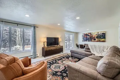 a living room with a couch and a flat screen tv at Charming 3 BDR for 8 in the Heart of the Rockies in Frisco