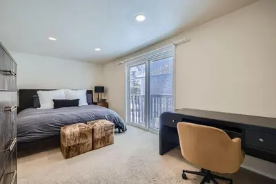 a bedroom with a bed and a desk and a chair at Charming 3 BDR for 8 in the Heart of the Rockies in Frisco