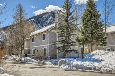 a house in the snow with trees in front of it at Charming 3 BDR for 8 in the Heart of the Rockies in Frisco