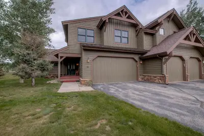 a large house with a garage and a driveway at Spacious 4BR Near Trails with Shuttle to Slopes in Breckenridge