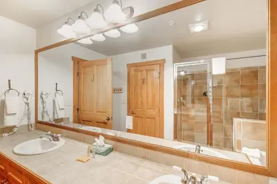 a bathroom with a sink and a large mirror at 3 BDR for 10 with Pool & Hot Tub Mins to Ski Lift in Dillon